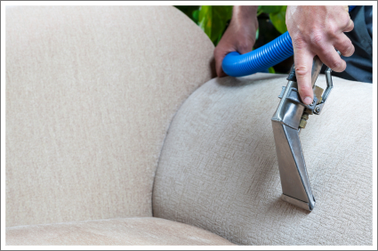 Professional upholstery cleaning of a fabric sofa cushion